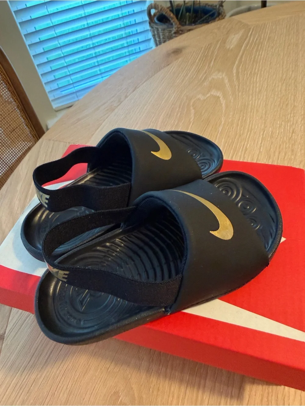 Nike Kids Black Slides with Gold Swoosh and Heel Strap